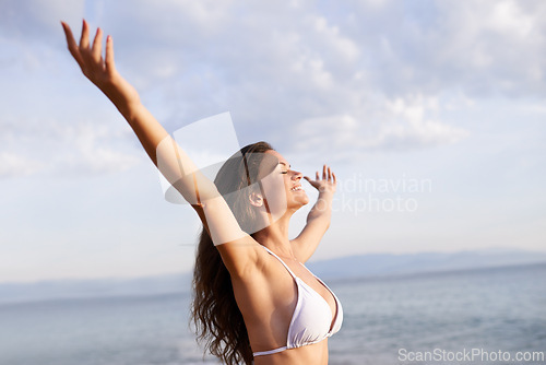 Image of Peace, hands up or happy woman at sea for travel adventure to relax on holiday vacation. Bikini, breathe or female person at beach with open arms in nature for fresh air, freedom or gratitude in Bali