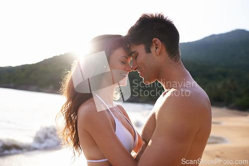 Image of Beach, date and couple with love at sunset on holiday or travel to Bali on vacation in summer. Tropical, island and man with gratitude for woman and smile with kindness, care and support together