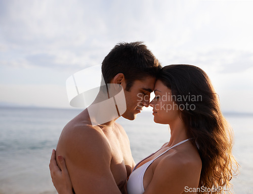 Image of Beach, date and couple with love on holiday, vacation or travel to sea together in summer. Romantic, moment and man with gratitude for woman and embrace with kindness, care and support for partner