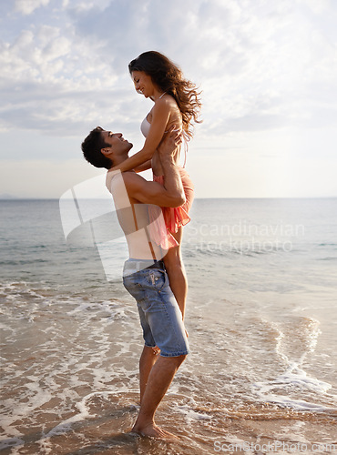 Image of Embrace, waves and couple playing on beach for travel adventure, summer island holiday and relax. Ocean vacation, woman and man in nature on romantic date together with smile, love and sea in Bali.
