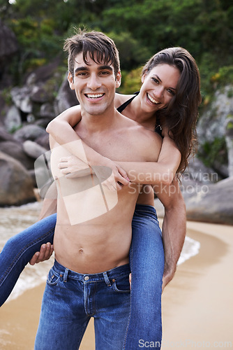 Image of Portrait, smile and piggyback with couple at beach together for travel, holiday or vacation in summer. Adventure, love or nature with happy young man and woman on sand by sea or ocean for romance