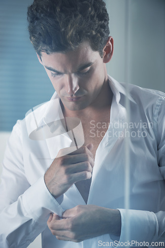 Image of Morning, shirt and business man getting ready in bedroom of home for start of career or work. Corporate, fashion and dressing with button on sleeve of young employee in apartment for professional job