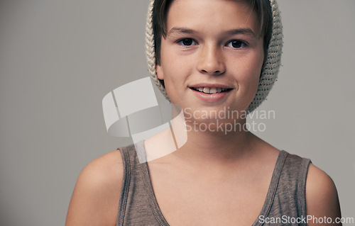 Image of Boy, child and beanie in studio for portrait with smile, teenager or edgy for fashion by background. Kid, model and hat for trendy style, happy and pride for clothes with confidence in hipster outfit