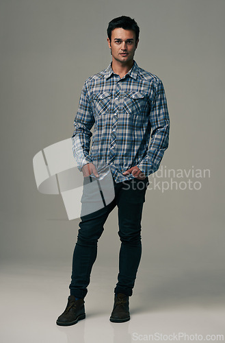 Image of Man, portrait and fashion with denim jeans, clothes or style on a gray studio background. Male person, adult or young model with casual clothing, shirt or stylish outfit in confidence on mockup space