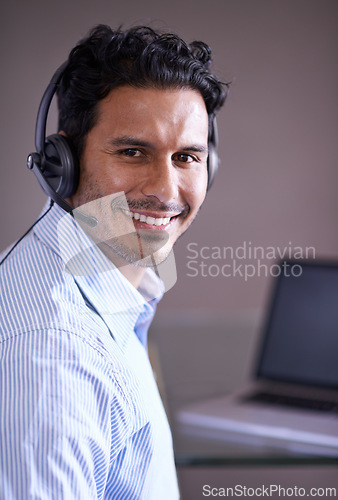 Image of Man, call center and portrait with contact us and smile for tech support, help desk and communication with headset. Customer service consultant, CRM and telecom with mic for telemarketing sales