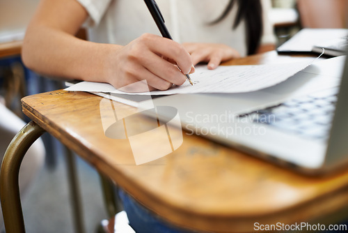 Image of Person, laptop and studying or writing for information, reading and connection for assignment in university. Student, scholarship or computer in college by desk, notes or online research for learning