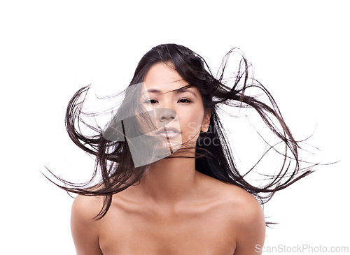 Image of Woman, portrait and windy for hair in studio, beauty and pride for keratin treatment on mockup space. Asian female person, breeze and shampoo for cosmetic on white background, haircare and creative