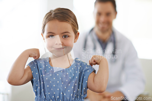 Image of Pediatrician, young girl and arm with flex for strong, brave and happiness for treatment. Doctor, smile and child at clinic with success for test results, consultation and healthy immune system