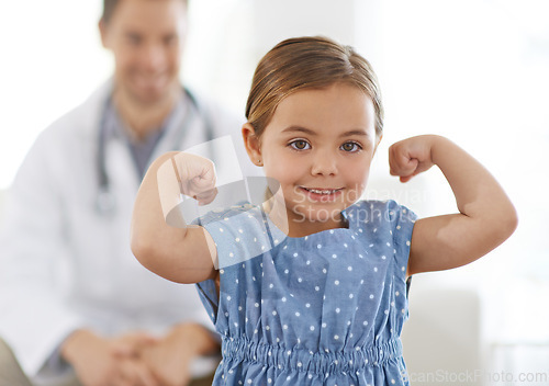 Image of Pediatrician, child and arm with flex for growth, brave and strong with happiness for treatment. Doctor, smile and child at clinic with success for test results, consultation or healthy immune system