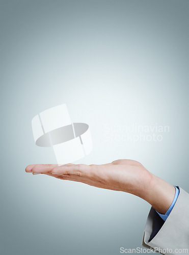 Image of Open, palm and business person with presentation, mockup and space on isolated on a grey studio background. Closeup, advertising and hand of professional with promotion or show platform for marketing