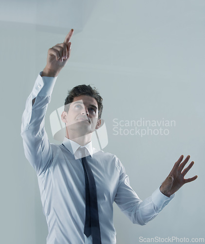 Image of Future, interface and business man user in studio on gray background for touchscreen biometrics. Internet, tech or virtual and young employee pointing to access database or metaverse information