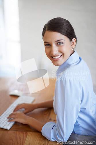 Image of Businesswoman, portrait and typing research in office as financial advisor for online loan, budget or accounting. Female person, face and keyboard for proposal planning or review, economy or startup