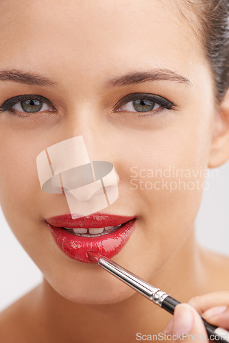 Image of Happy woman, portrait and red lipstick with makeup for beauty or facial cosmetics on a white studio background. Face or closeup of female person or model applying color, gloss or glow for cosmetology