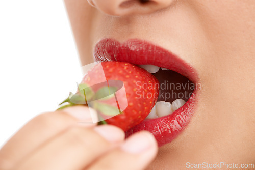 Image of Person, mouth and bite with strawberry, red lipstick or cosmetics for nutrition on a white studio background. Closeup of woman, teeth or organic fruit with makeup for diet, natural fiber or glow