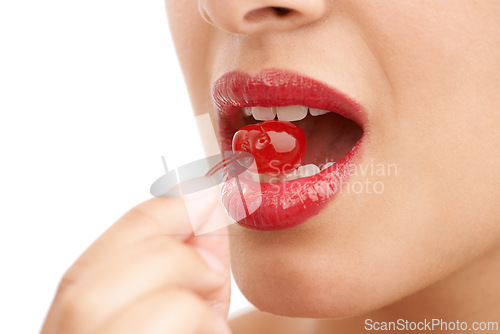 Image of Person, mouth and bite with cherry, red lipstick or cosmetics for nutrition on a white studio background. Closeup of woman, teeth or natural organic fruit with makeup or gloss for diet, fiber or glow