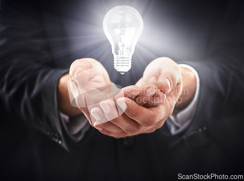 Image of Hands, light bulb glow and idea for business growth, development and professional problem solving. Person with insights, corporate innovation and knowledge with enlightenment and inspiration