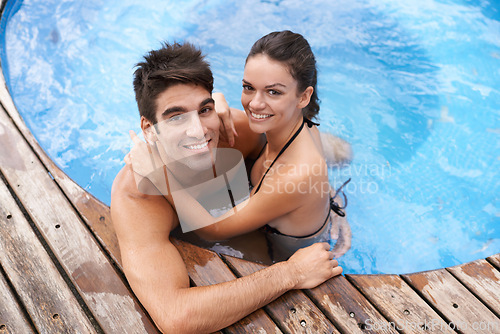 Image of Couple, jacuzzi and smile on vacation for happiness, date and summer to relax outdoor. Aerial view, relationship and holiday with pool for affection, romance and bonding with support together.