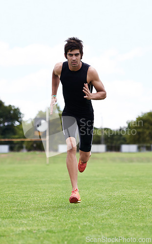 Image of Athlete man, run and outdoor for race, jog and activewear in workout and training for wellness and portrait motion. Cardio, wellbeing and sport for exercise, health and fitness on grass for summer