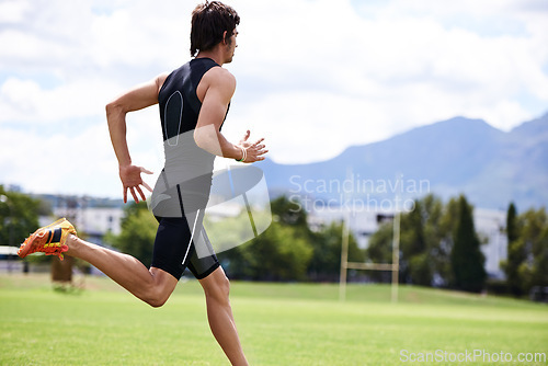 Image of Athlete male person, run and outdoor for race, jog and activewear in workout and training for wellness and sprint. Cardio, wellbeing and sport for exercise, health and fitness on grass for summer