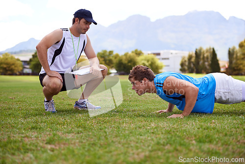 Image of Men, push up and personal trainer on grass for exercise with clipboard for stats, progress or development. Person, coach or mentor with checklist for schedule, training or workout for health on field