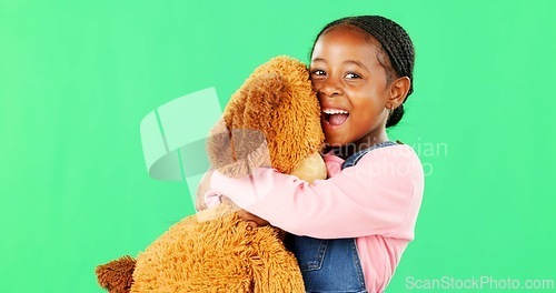 Image of Green screen, love and a black girl hugging her teddy bear in studio in excitement or comfort. Portrait, happy and embrace with an adorable little female child holding her stuffed animal on chromakey