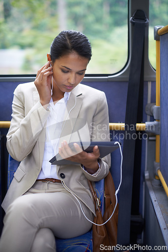 Image of Woman, streaming and travel on bus with tablet and earphones for journey and transport in outdoor. Business person and research with formal clothes and tech online for communication and commute