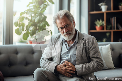 Image of Senior Man Contemplating Alone on a Sofa at Home