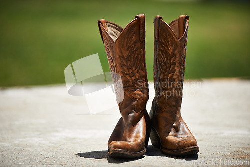 Image of Cowboy, boots and vintage in outdoor fashion, shoes and leather for horse riding. Countryside, style and design for footwear with pattern, stitching and western landscape or grassland and farm