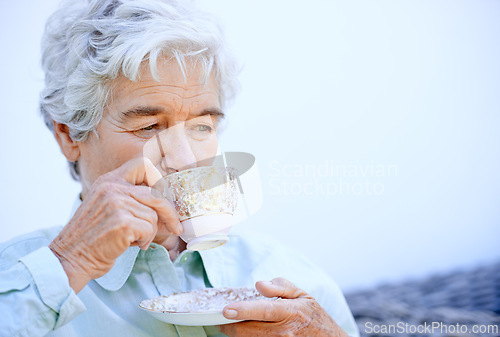 Image of Senior woman, thinking and relax with coffee or tea and calm for outdoor. Elderly person, holding cup and comfortable in peace retirement, carefree and drink caffeine in nursing home for break