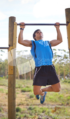 Image of Athlete, man and exercise with pull up for training, health and wellness at park. Bodybuilder, workout and cardio in nature for fitness, strong muscle and person for sports or competition or hobby