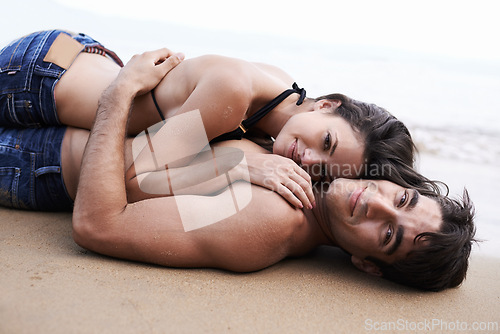 Image of Couple, beach and lying with smile on vacation for bonding, love and break on summer in Mauritius. Relationship, holiday and travel for happiness with affection for memory, leisure and embrace.