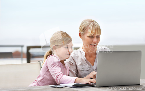 Image of Mother, child and laptop on a patio with elearning, game and internet with love, support and bonding. Tech, smile and mom with teaching and education app with young girl on a website for home school