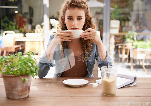 Image of Woman, beverage and portrait in coffee shop with book for relaxing, reading or studying. Young female person or author sitting alone for reviews, research or break at cafe in Dublin with caffeine