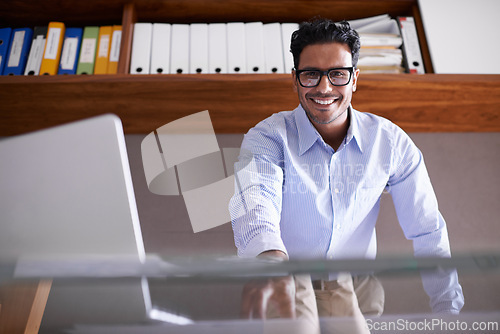 Image of Portrait, office and business man with laptop for internet, website and online project by desk. Professional, corporate consultant and worker with computer for planning, networking and connection