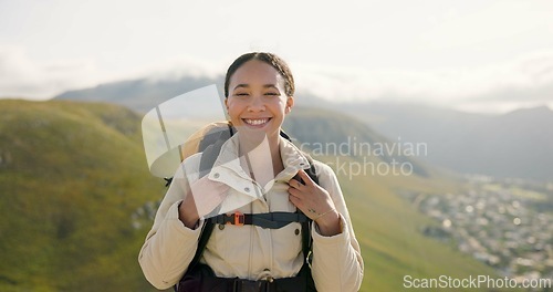 Image of Happy woman, face and backpack with mountain for hiking, adventure or outdoor journey in nature. Portrait of female person, tourist or hiker smile with bag for trekking or climbing on cliff or hills