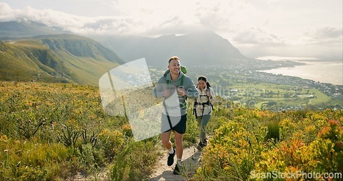 Image of Couple of friends walking, hiking on mountain and travel for fitness, adventure or journey in nature for wellness. Young people trekking with backpack on a path or green hill for cardio and health