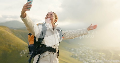 Image of Woman, trekking on mountains and selfie or video call for hiking, adventure and eco friendly blog on social media. Vlogger or influencer with live stream, travel or journey on a hill, rock and nature