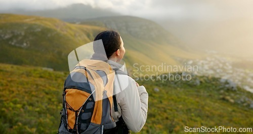 Image of Back of woman, hiking and mountains for outdoor wellness, fitness and health in nature and cityscape. Sports person in wind with backpack and trekking on a hill for adventure, travel and eco journey