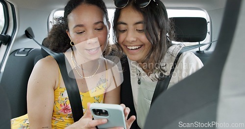 Image of Happy friends, phone and car for road trip information, location search and social media. Young women reading on mobile app and talking of travel, holiday and transportation service with funny chat