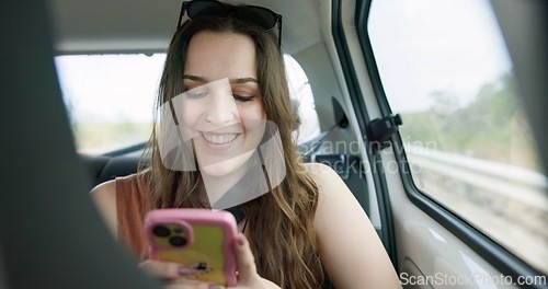 Image of Happy woman, phone and social media in car for travel, communication or networking in transportation. Female person smile on mobile smartphone in vehicle for online chatting, texting or road trip