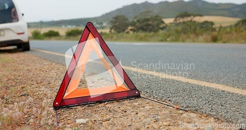 Image of Road, triangle and car breakdown for shape, sign or vehicle assistance in the outdoor countryside. Asphalt, street or sidewalk safety symbol for warning, signal or traffic control to alert attention
