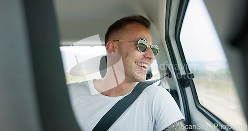 Image of Happy man, car and sunglasses on road trip in backseat for travel, journey or adventure in the countryside. Male person smile in joy looking out vehicle window for natural scenery, holiday or weekend