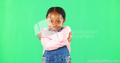 Image of Girl, child and smile with hug for self love in portrait with fashion, pride and empowerment by green screen. African kid, happy and embrace with kindness, excited or growth with mockup for promotion