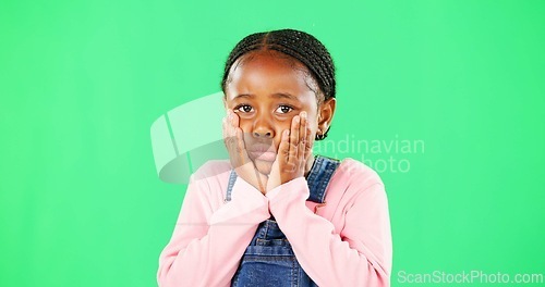 Image of Portrait, sad and kid on green screen in studio isolated on a mockup space background. Face, hands or unhappy African girl child on chroma key, depression or disappointed facial expression of emotion