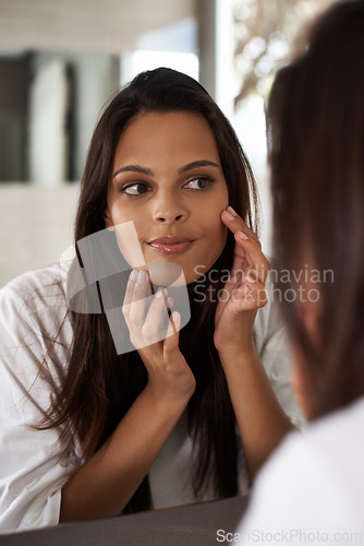 Image of Woman, check skin in mirror and beauty with morning routine, acne and cosmetic care at home. Skincare, wellness and dermatology with facial glow, reflection and grooming for hygiene in bathroom