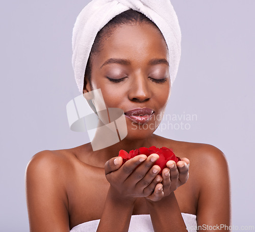 Image of Towel, skincare and black woman with red petals, beauty and dermatology on a white studio background. Happy, African person and model with natural cosmetics and grooming with treatment and luxury