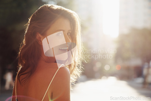 Image of Portrait, happy and woman with sunshine, city and confidence with weekend break and travelling. Face, person and New York with girl and summer with journey and adventure with lens flare and street