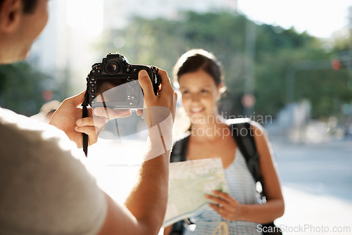 Image of Tourist, hand and photographer with camera in street for travel, sightseeing and memories on holiday or vacation. People, person and smile in city road for explore, tourism or journey in urban town