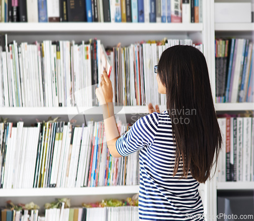 Image of Student, woman and back by bookshelf with search, studying and development at university for knowledge. Person, girl and research in library with books, check and inspection for learning at college