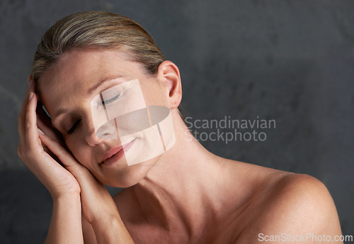 Image of Mature woman, studio and nude for beauty, skin care and natural look in self love moment of thought. Old caucasian female person, face and dreaming in grey background, body and naked confidence